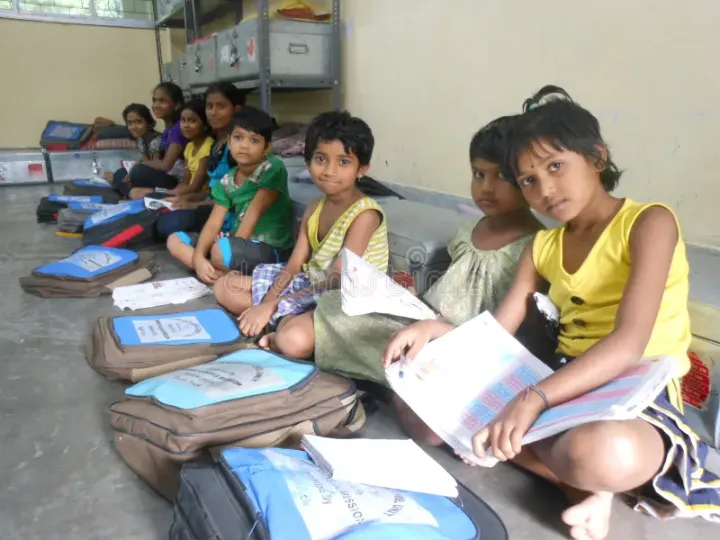 Photo of a rural classroom with no computers, kids using outdated textbooks